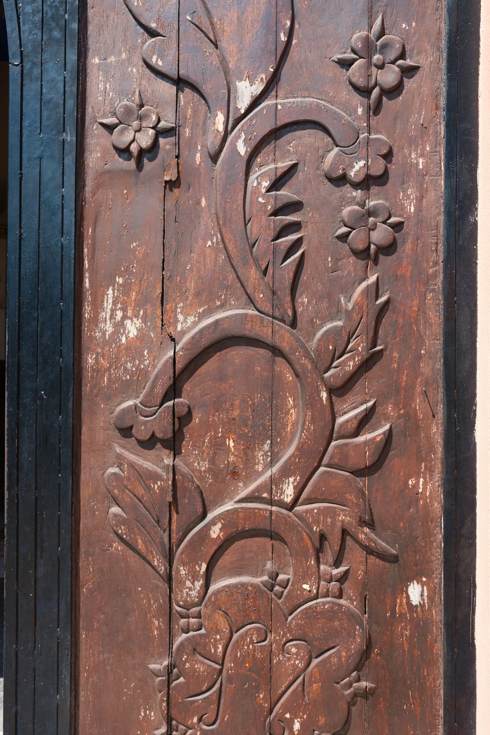 a close up of a wooden door with carvings on it