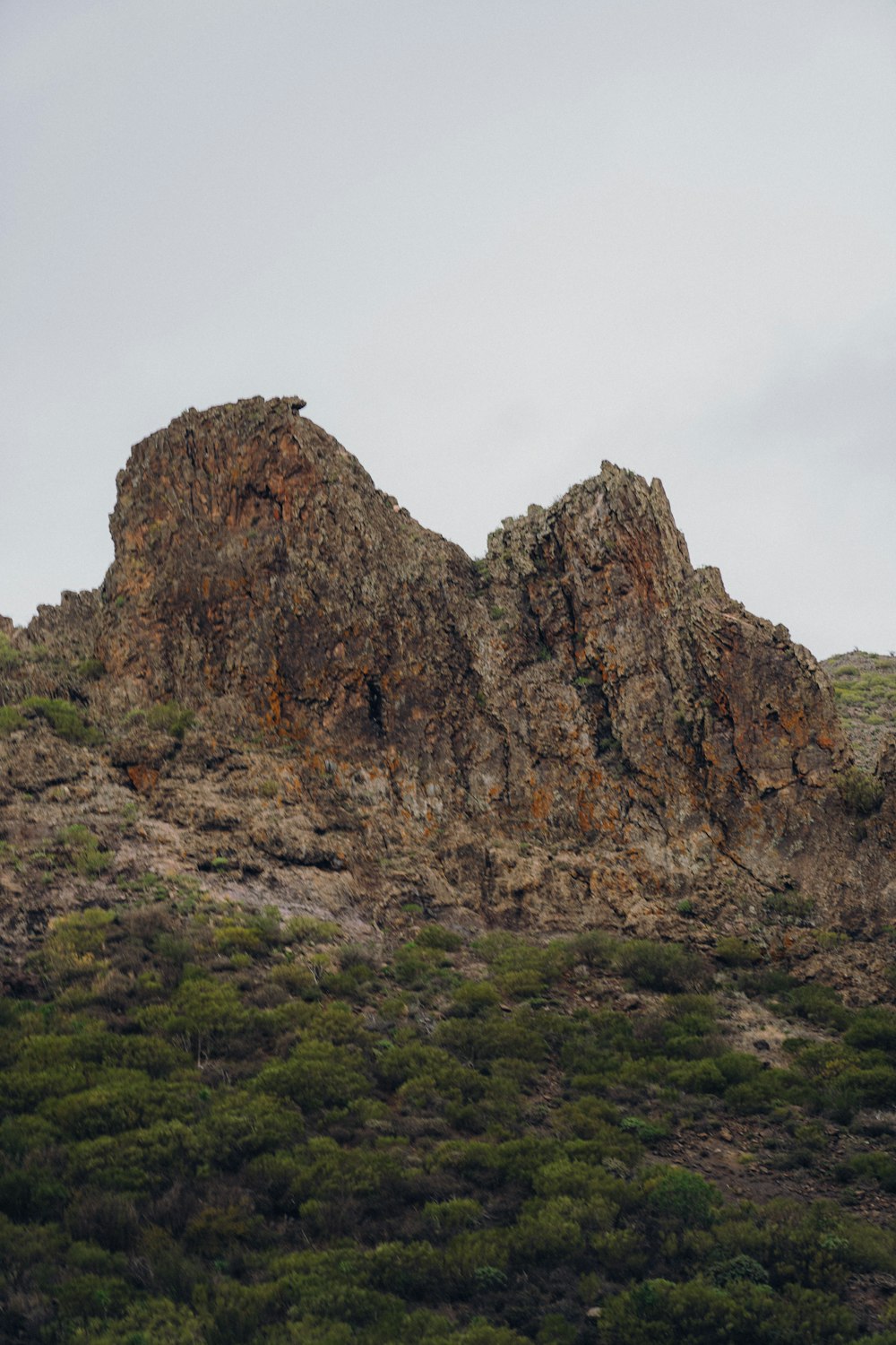 a large rock formation in the middle of a field