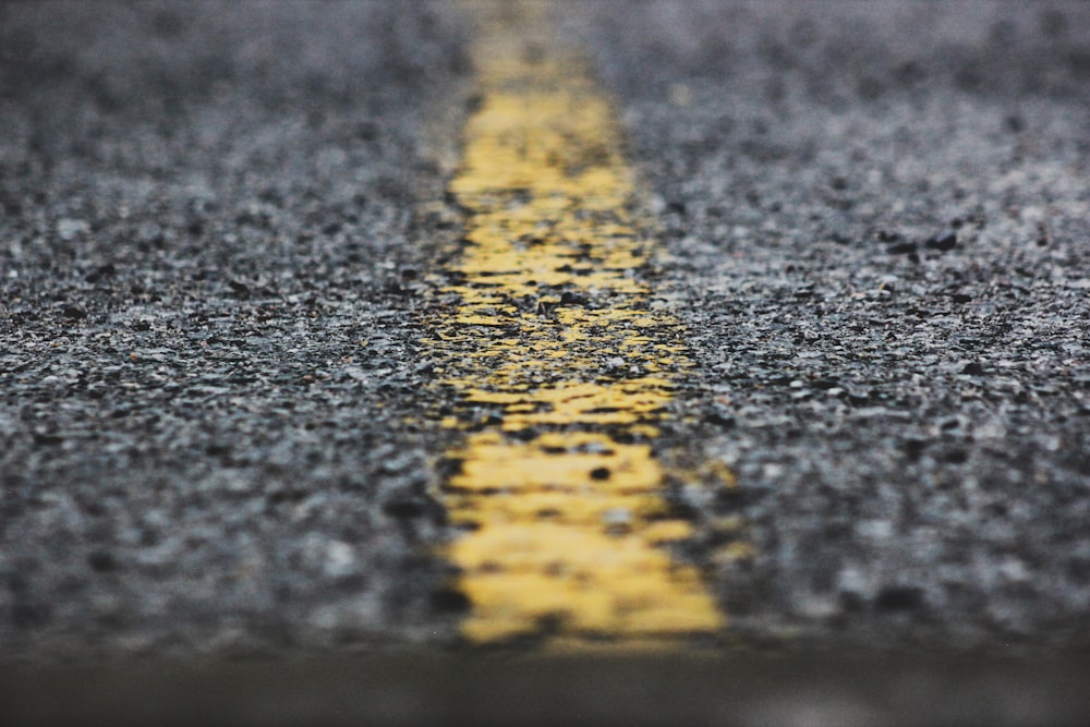 a yellow line painted on the side of a road