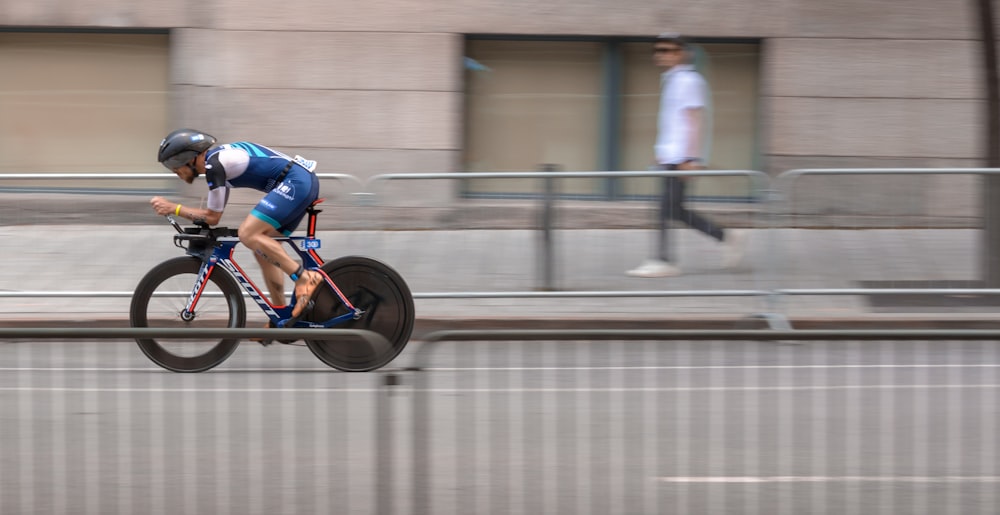 a man riding a bike down a street