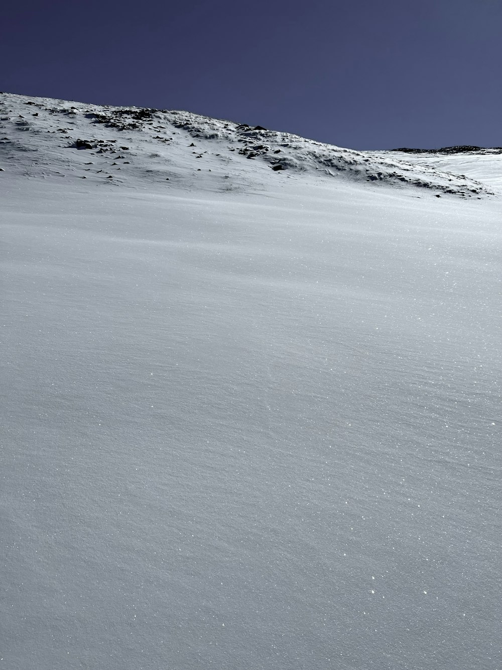 a man riding skis down a snow covered slope