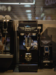 an espresso machine sitting next to a coffee maker