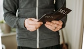a person holding a cell phone in their hands