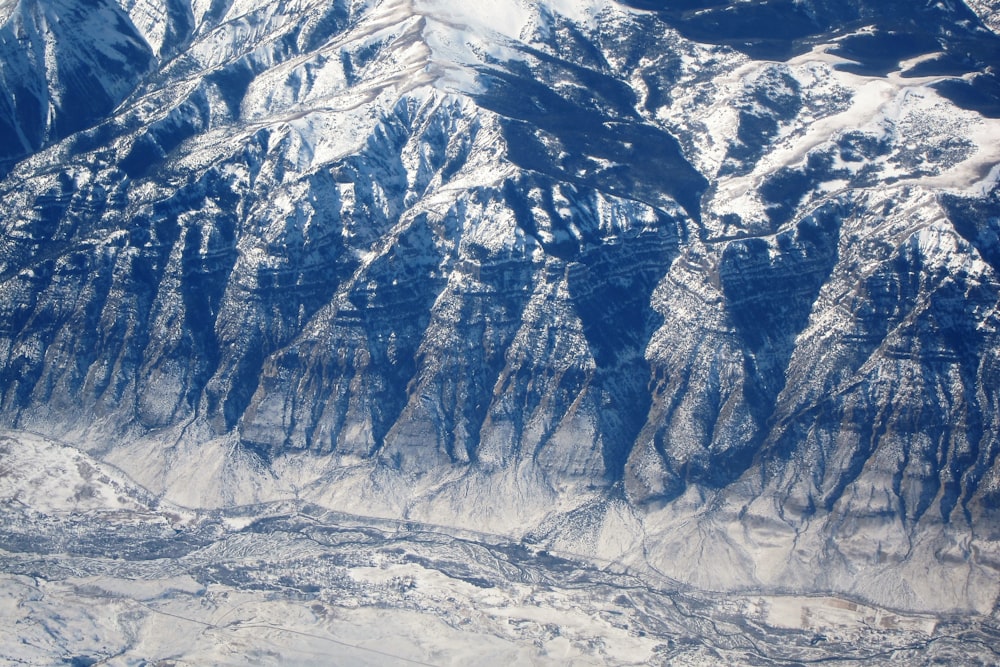 an aerial view of a snowy mountain range