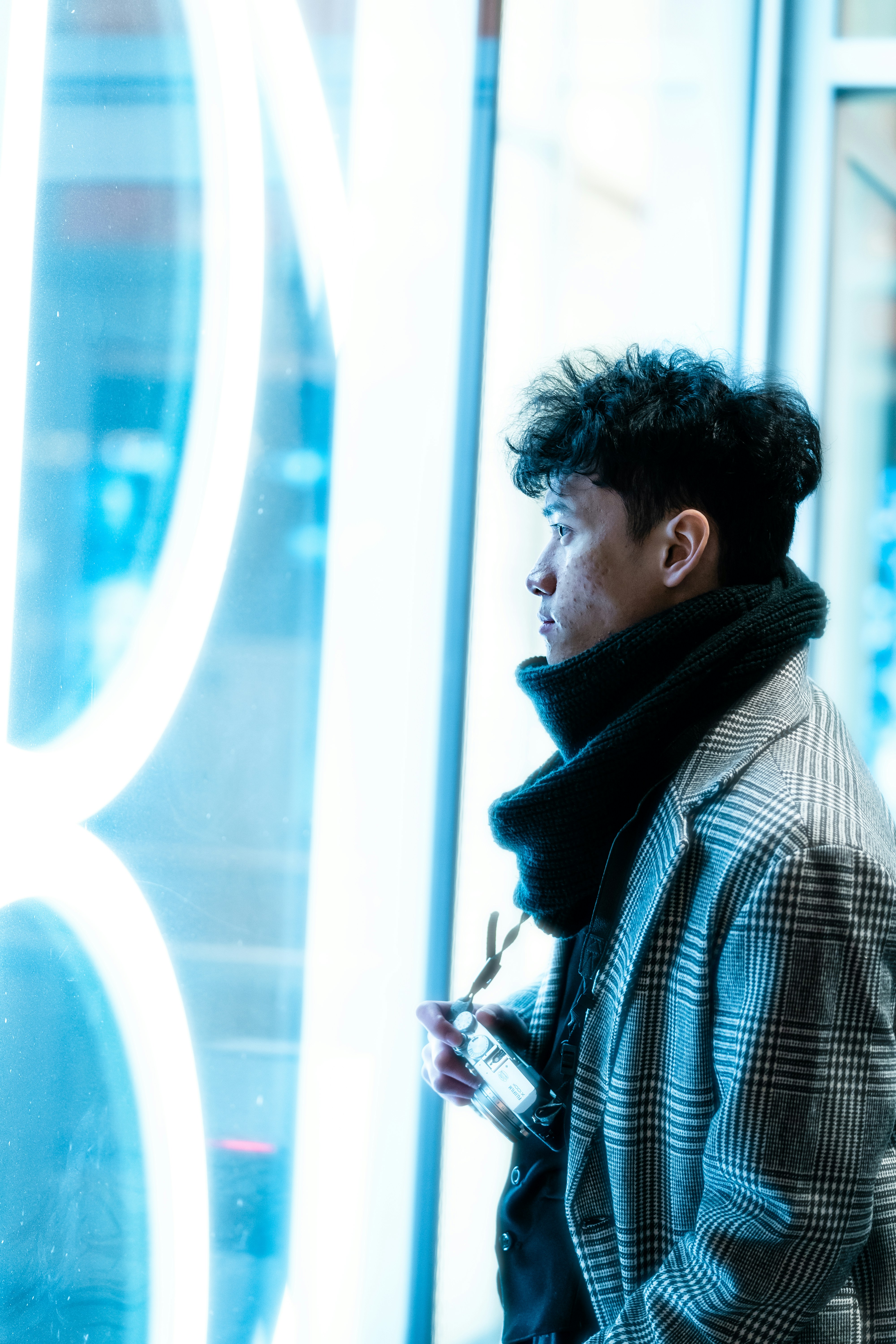 a man standing in front of a large window