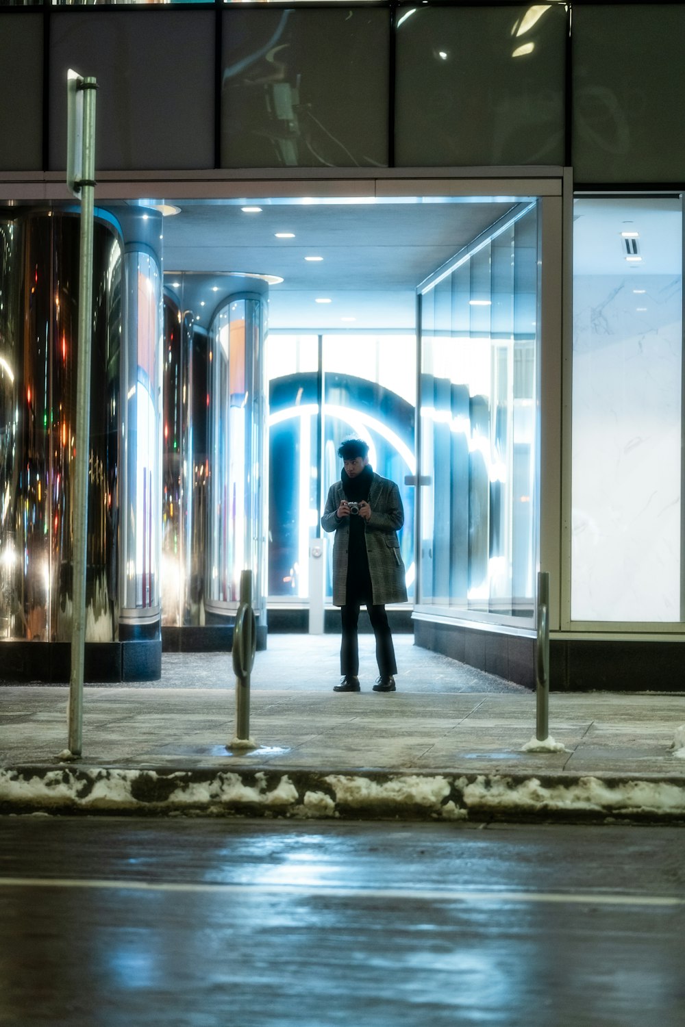 a man taking a picture of himself in front of a building