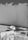 A section of a wall is being painted. The surface appears partially covered with paint, and various painting supplies are present, including a large paint bucket and a brush. The ground is protected with plastic sheets, and there is a close-up of paint on a tool in the foreground.