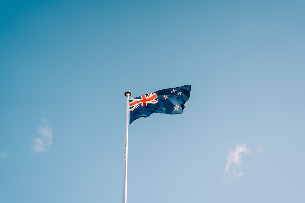 a flag flying in the wind on a clear day