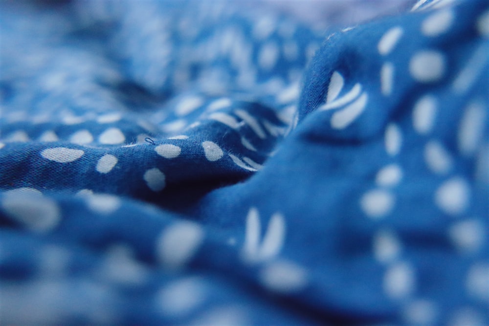 a blue and white blanket with white polka dots