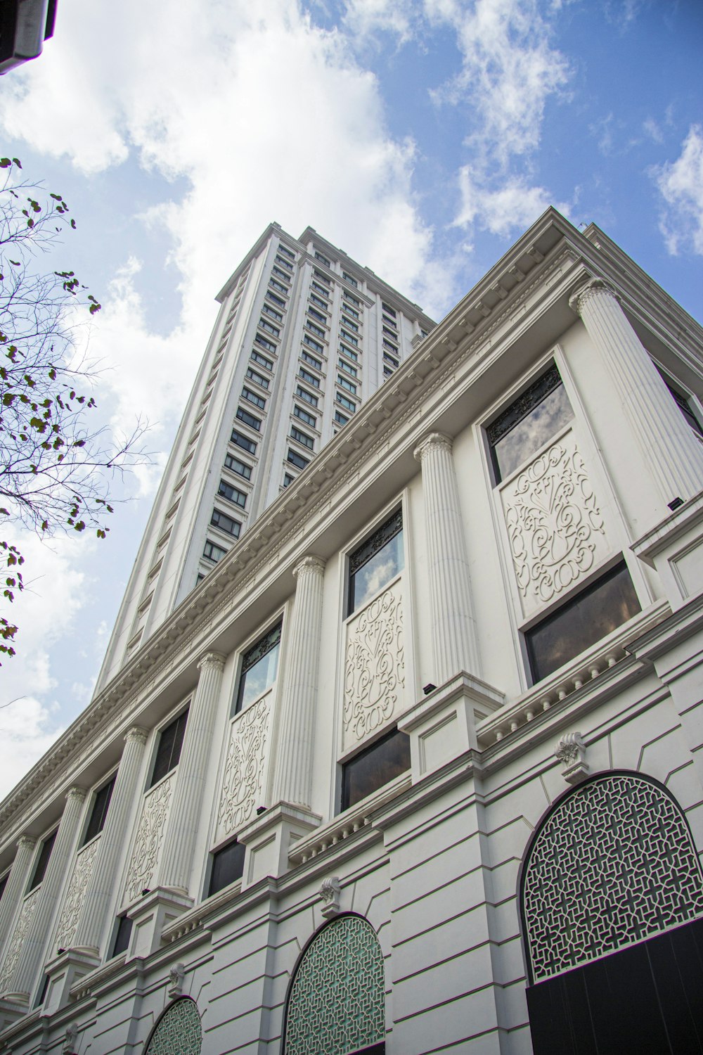 a tall white building with a sky background