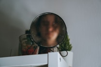 a close up of a magnifying glass on a shelf