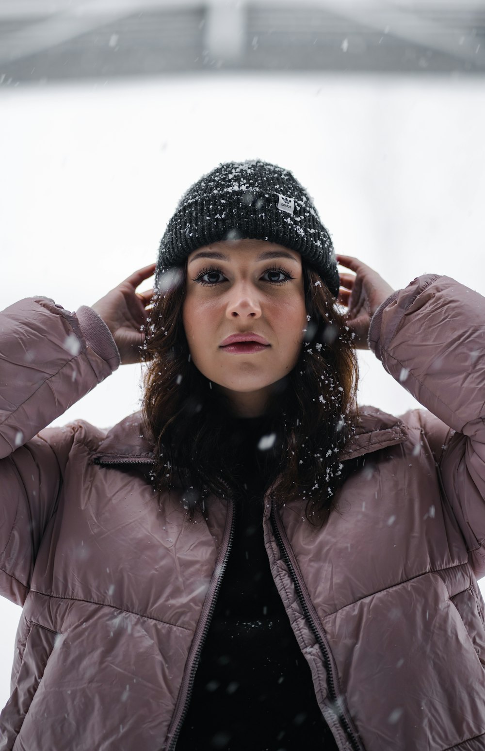 a woman wearing a winter coat and a beanie