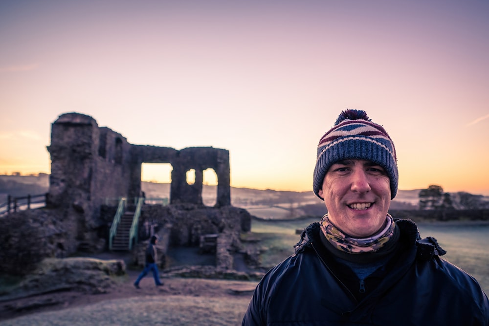 a man standing in front of an old building