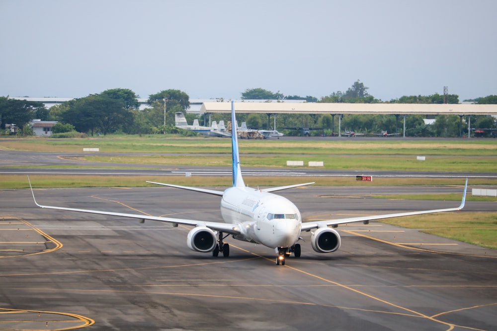 a large jetliner sitting on top of an airport runway