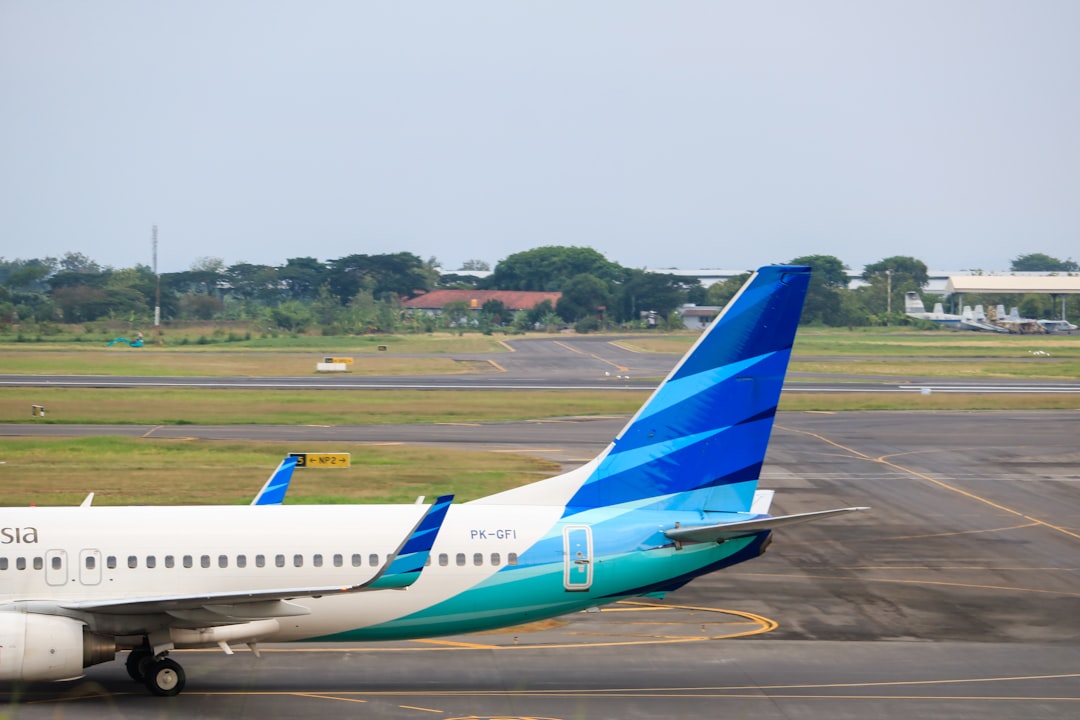 a large jetliner sitting on top of an airport tarmac, Garuda Indonesia arrived in The Juanda International Airport. The 