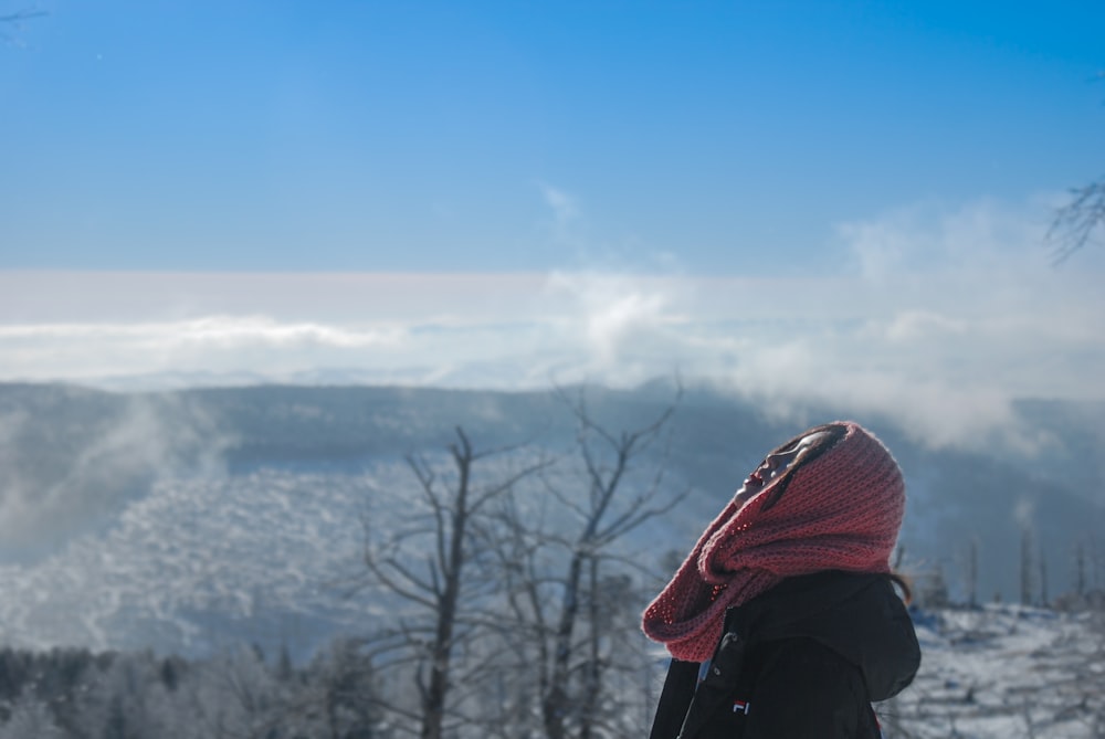Una persona parada en la cima de una pendiente cubierta de nieve