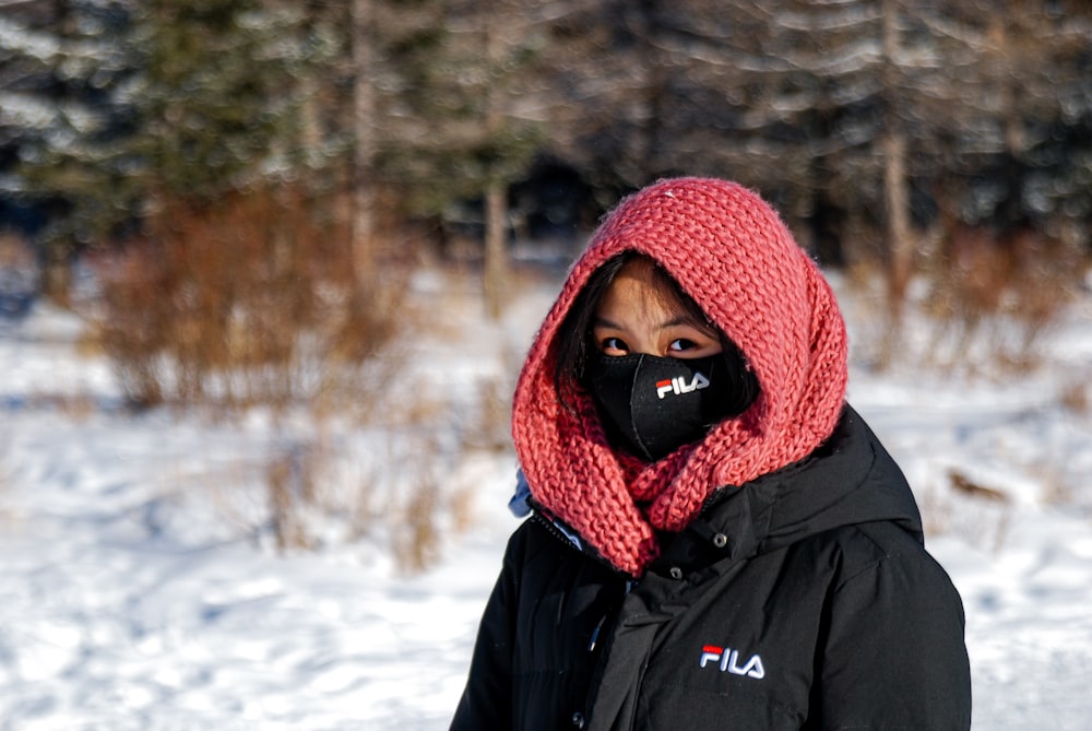 a woman wearing a face mask in the snow