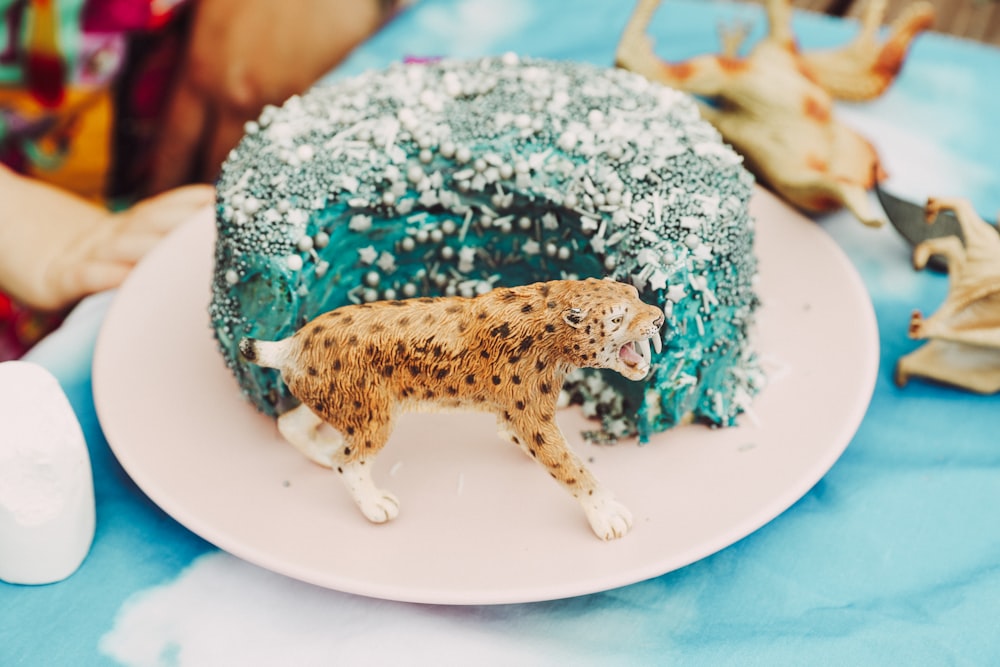 a cake with a leopard figurine on top of it