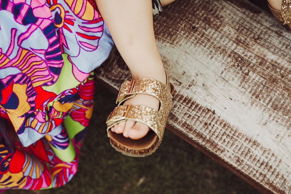 a close up of a person's feet wearing sandals