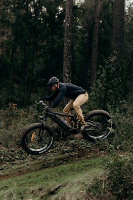 a man riding a mountain bike down a trail