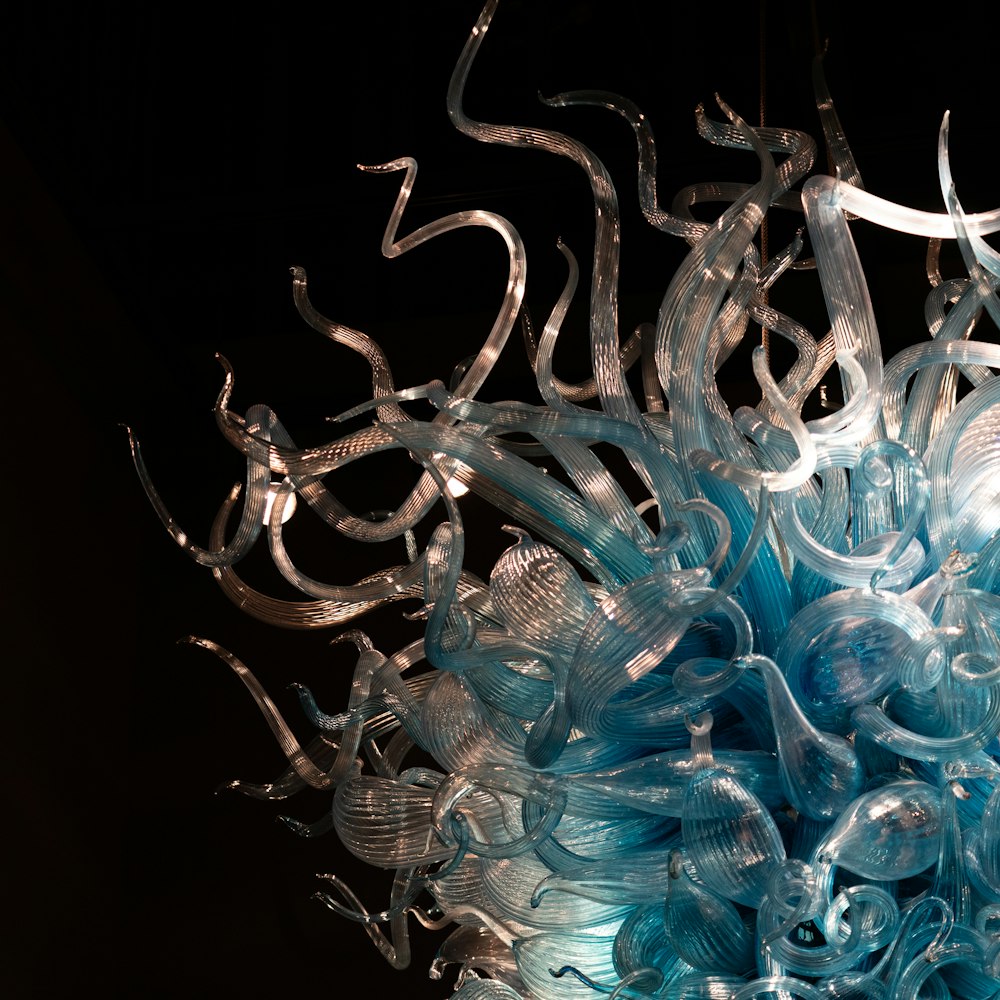 a blue and white glass sculpture hanging from a ceiling
