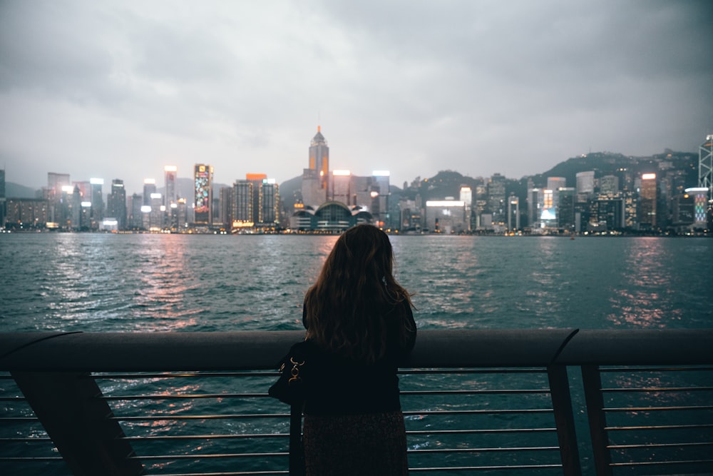 a woman looking out over a body of water