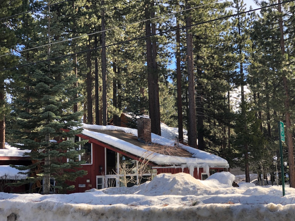 a cabin in the woods with snow on the ground