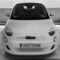 a small white car parked in a parking lot