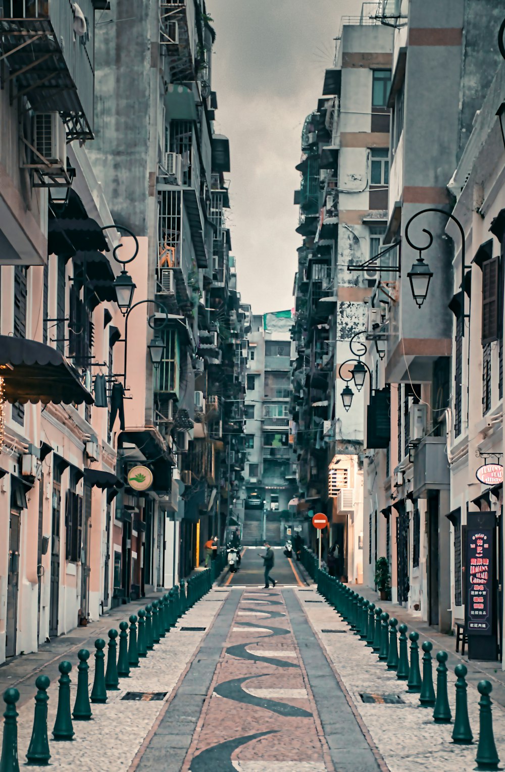 a narrow city street lined with tall buildings