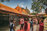 Devotees walking along vibrant decorated pathways leading to temples