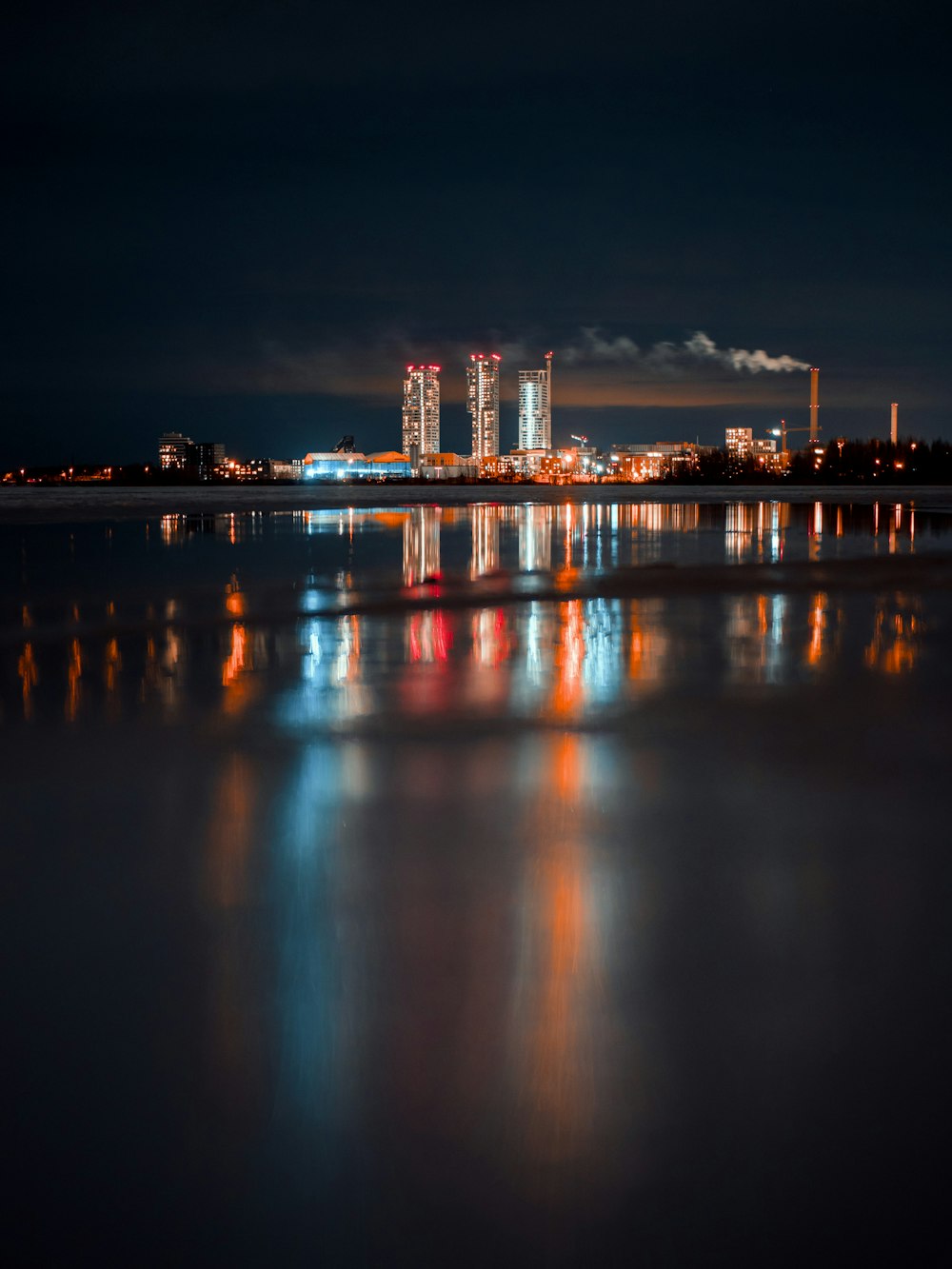 a large body of water with a city in the background