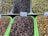 Several trays of olives in different colors, including green, black, and brown. Each tray is labeled with a price tag. The olives are glossy, indicating freshness, and arranged neatly in a market setting.