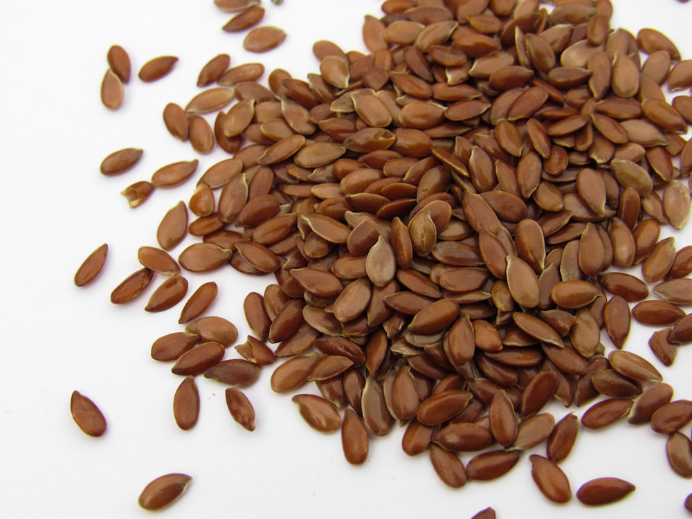 a pile of sunflower seeds on a white surface