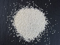 a pile of white rice sitting on top of a black surface