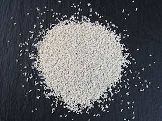 a pile of white rice sitting on top of a black surface