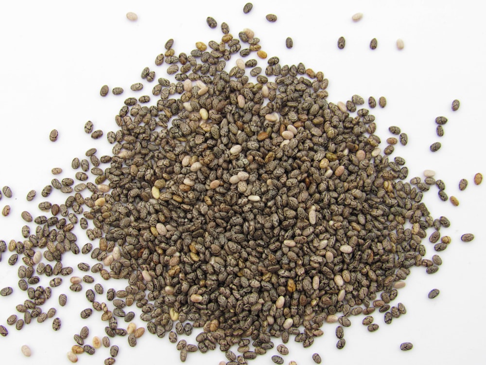a pile of seeds on a white surface
