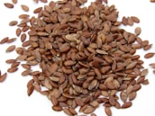 a pile of sunflower seeds on a white surface