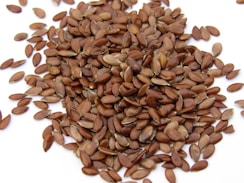 a pile of sunflower seeds on a white surface