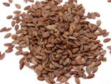 a pile of sunflower seeds on a white surface