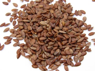 a pile of sunflower seeds on a white surface