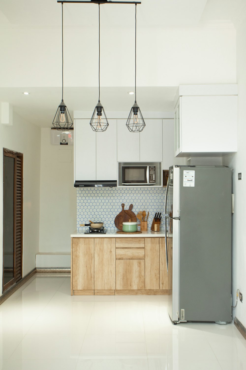 a kitchen with a refrigerator freezer sitting next to a stove top oven