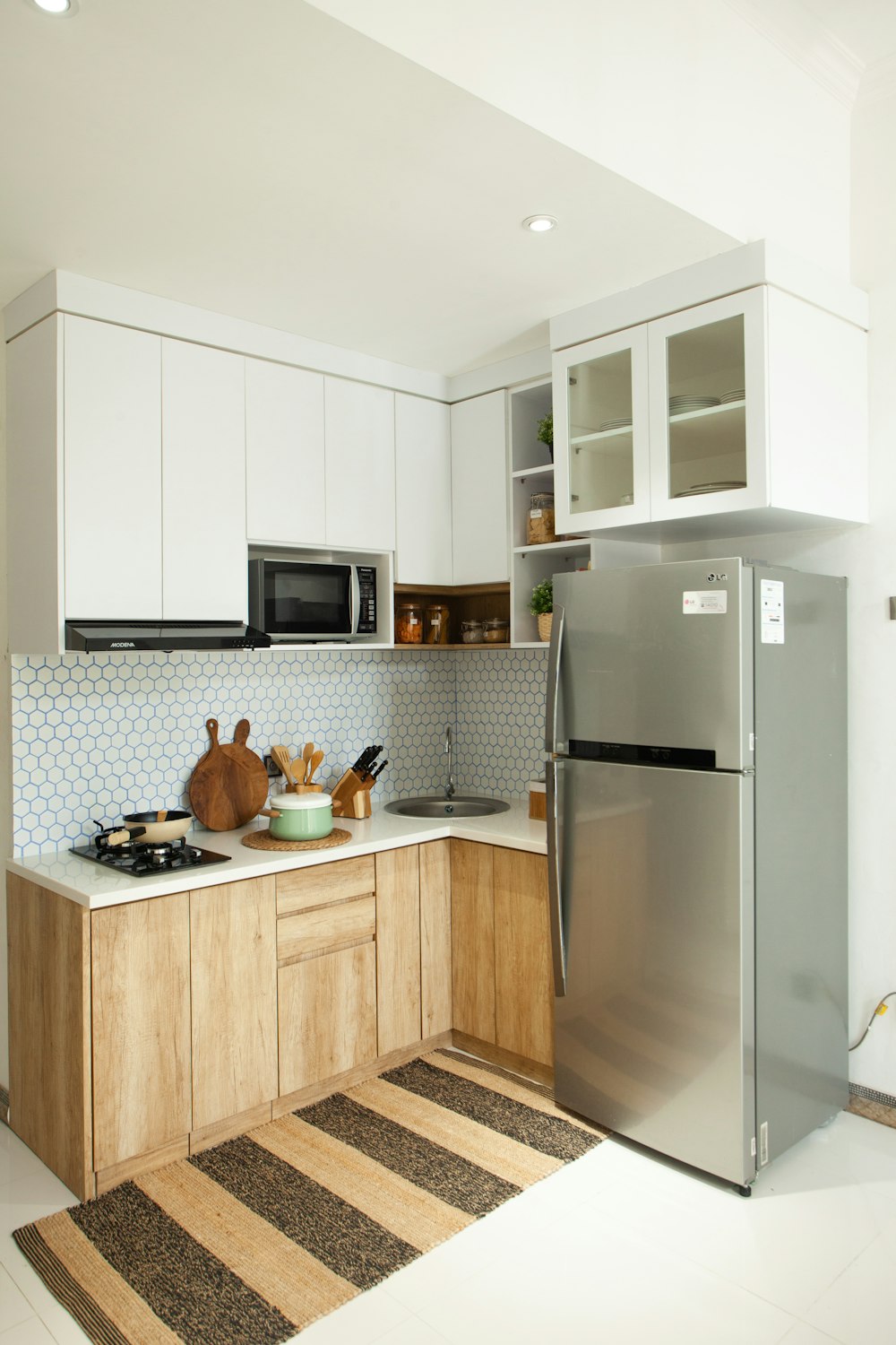 a kitchen with a silver refrigerator freezer next to a stove top oven