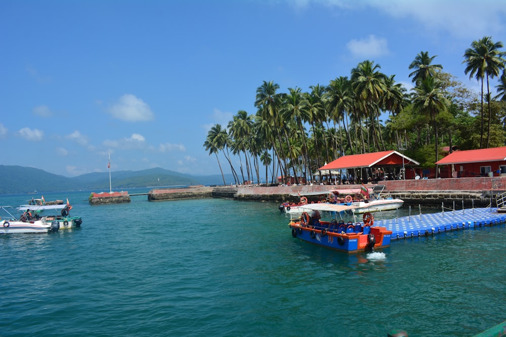 a group of boats floating on top of a body of water