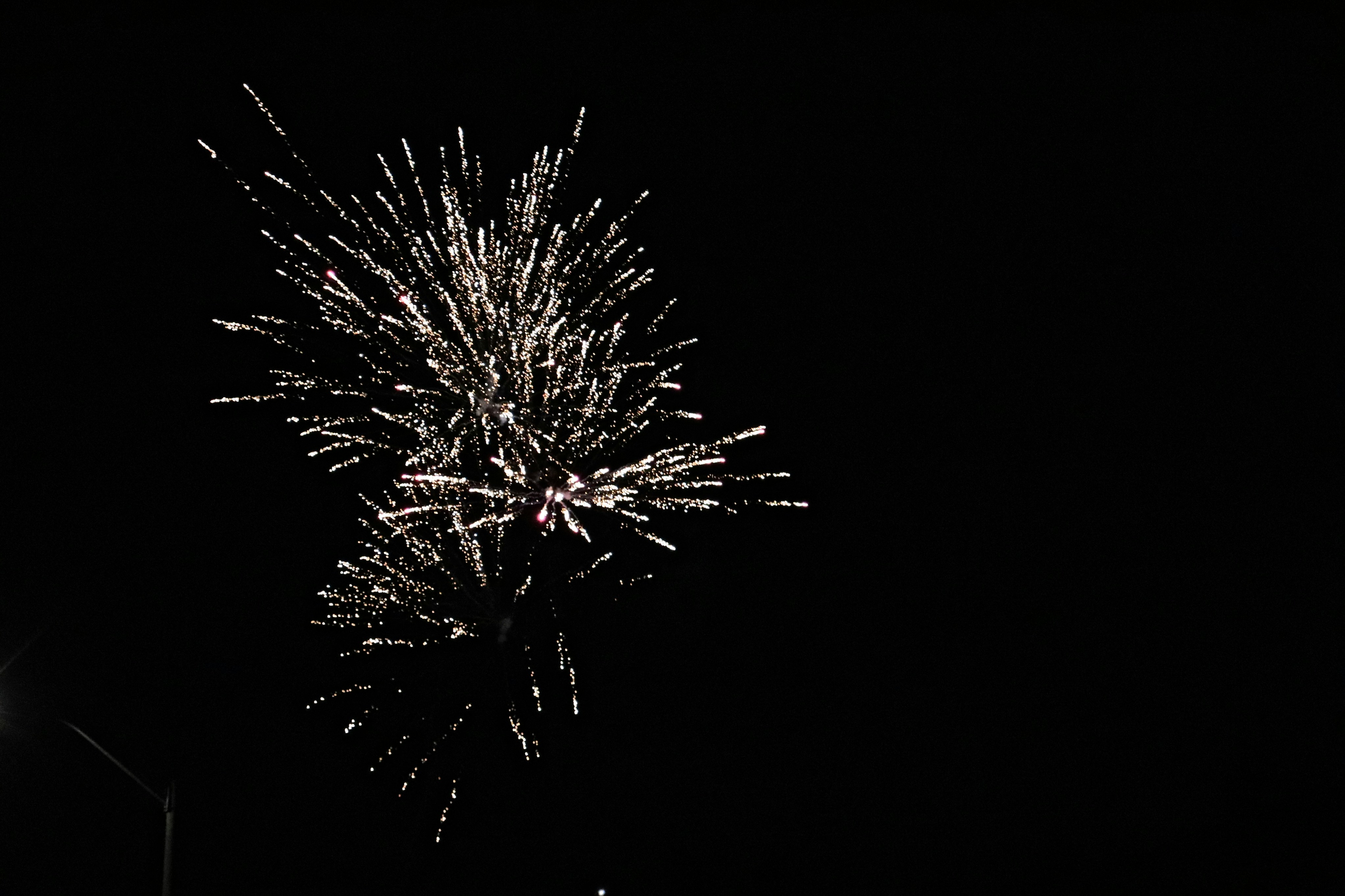 a fireworks is lit up in the dark sky