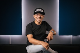 a man sitting on top of a black couch