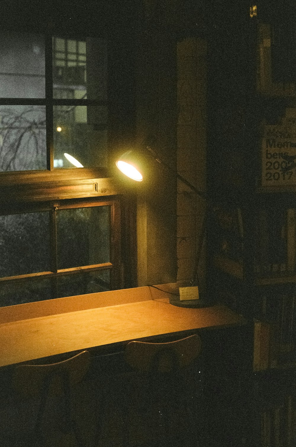 a desk with a lamp on it in a dark room