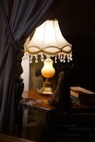 An elegant nautical lamp with a polished brass finish, resting on a wooden table.