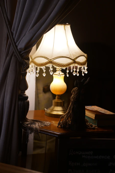 Elegant marble base table lamp casting a warm glow on a wooden desk