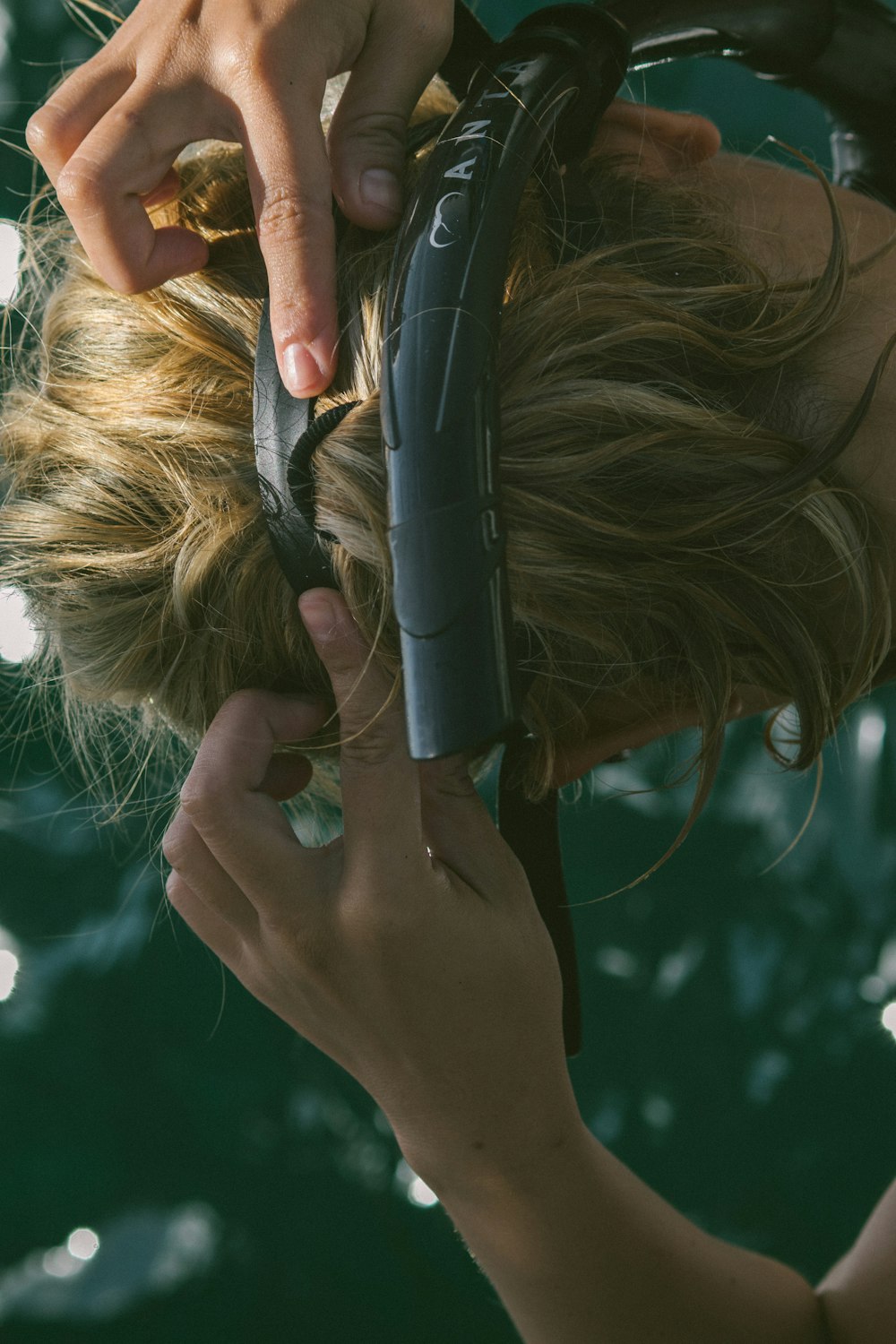 a woman is using a hair dryer on her hair