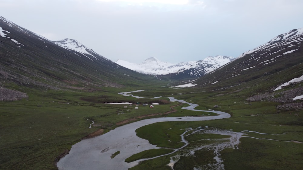 a river running through a lush green valley